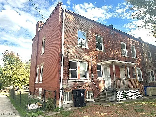 View of front facade with brick siding and a gate