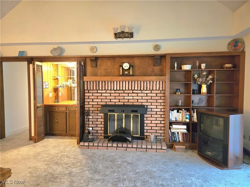 Wet Bar,, brick, gas fireplace, custom shelving built-ins. Cathederal and beamed ceiling for ambiance.