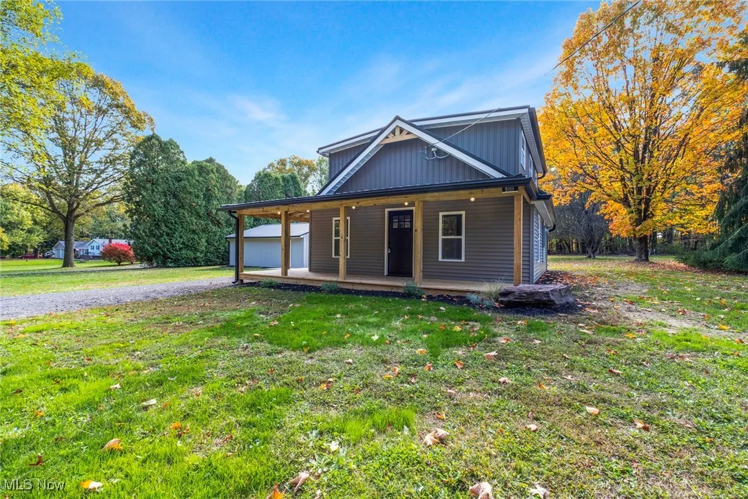 View of front of house with a front yard and covered porch