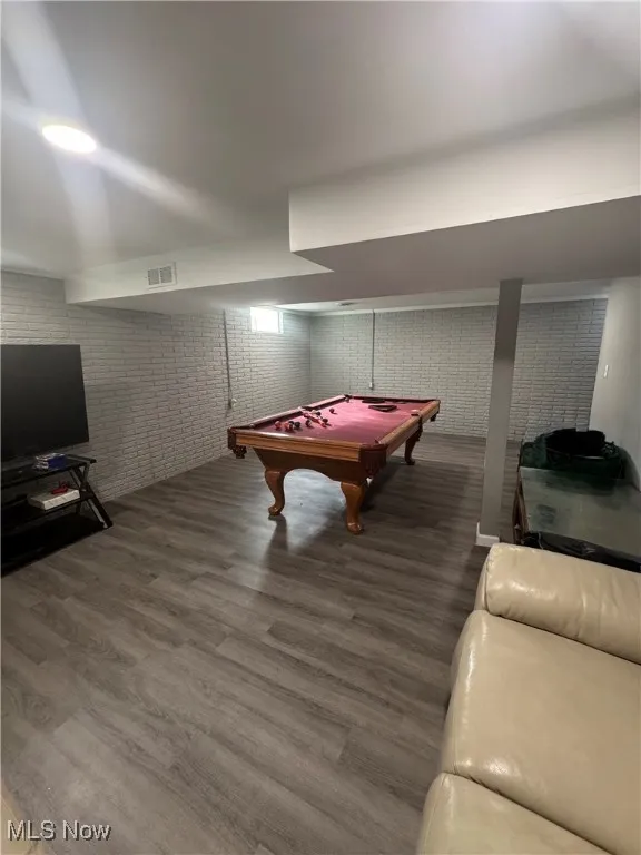 Recreation room with billiards table and wood finished floors