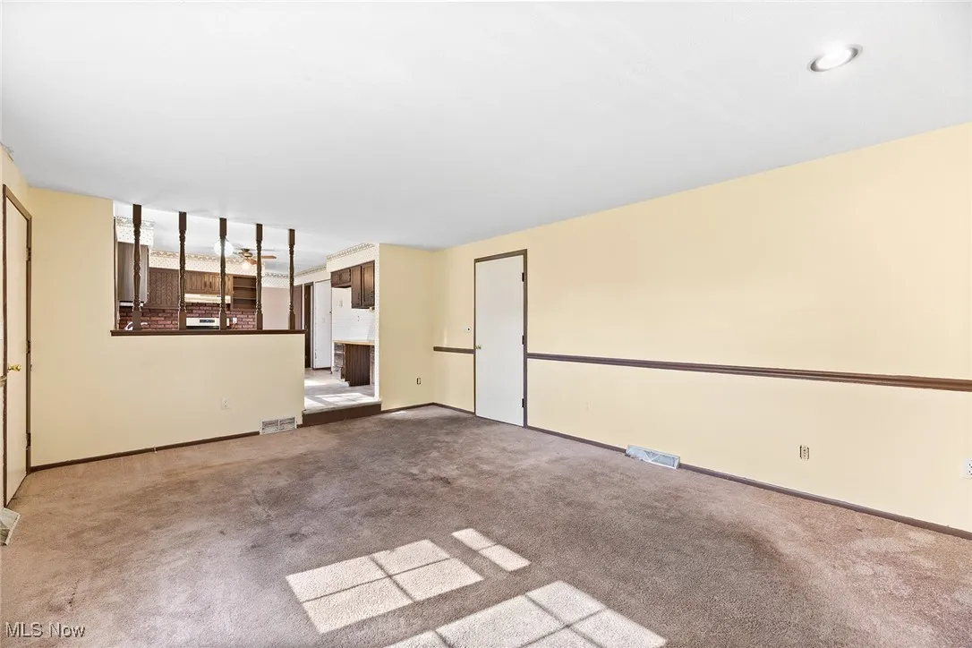 Empty room featuring carpet floors and baseboards