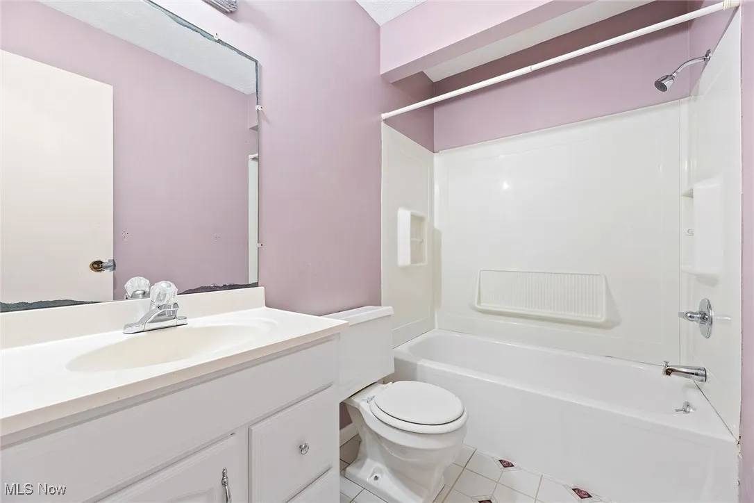 Bathroom with  shower combination, vanity, and light tile patterned flooring