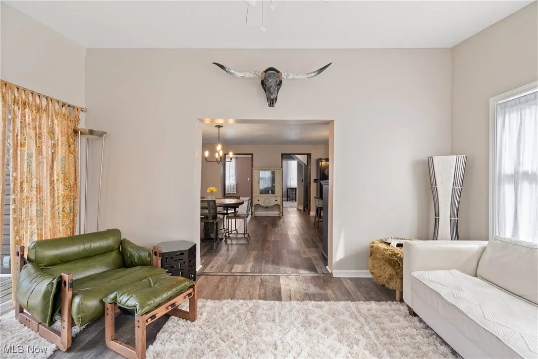 Sitting room with wood finished floors and a chandelier