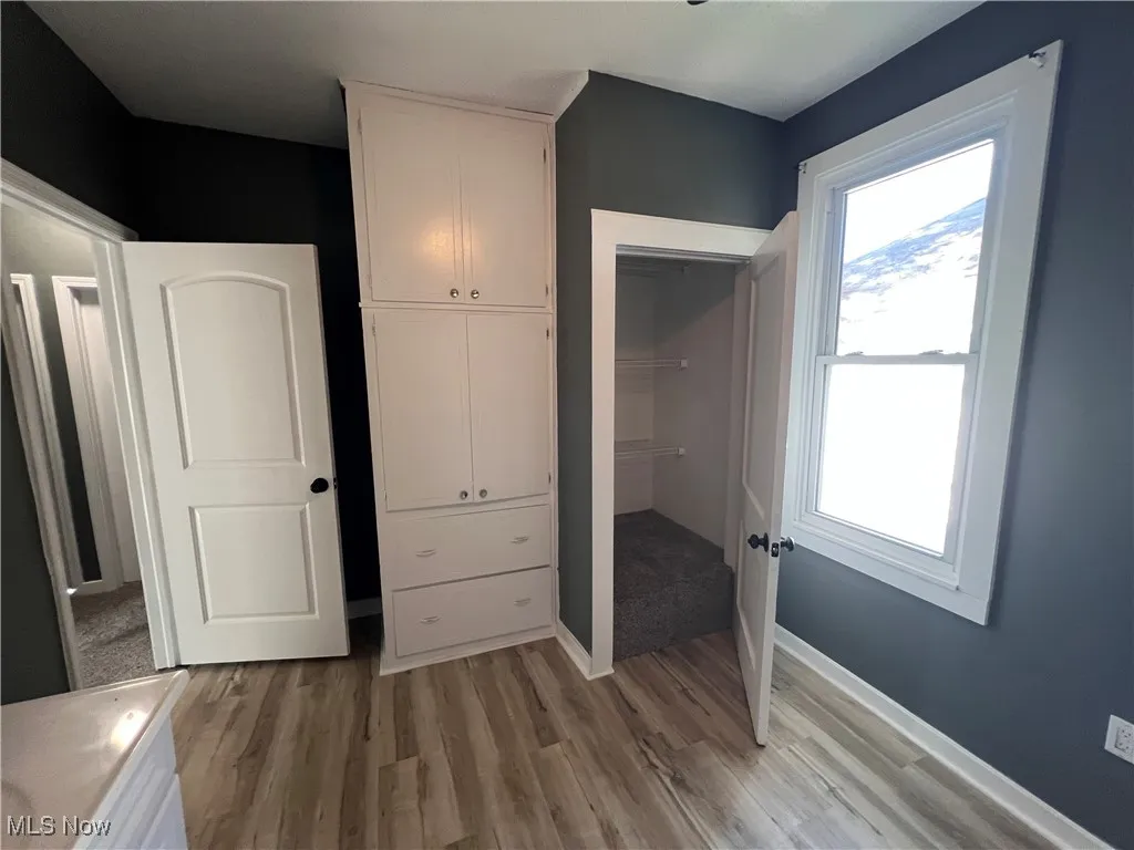 Unfurnished bedroom with light wood-type flooring and a closet
