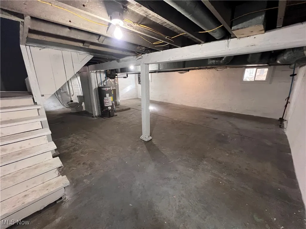 Basement with gas water heater and stairs