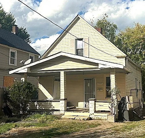 Back of property featuring a porch and a chimney