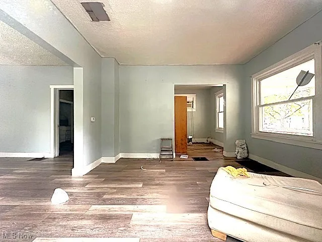 Bedroom featuring a textured ceiling and wood finished floors