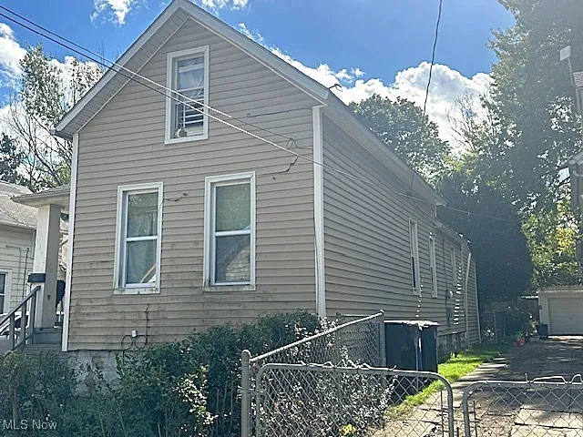 View of home's exterior featuring a detached garage and an outbuilding
