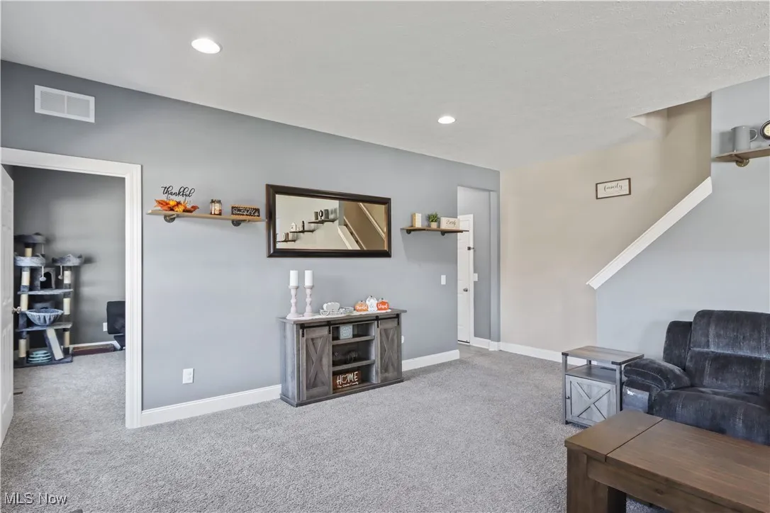 Living area featuring carpet flooring and recessed lighting