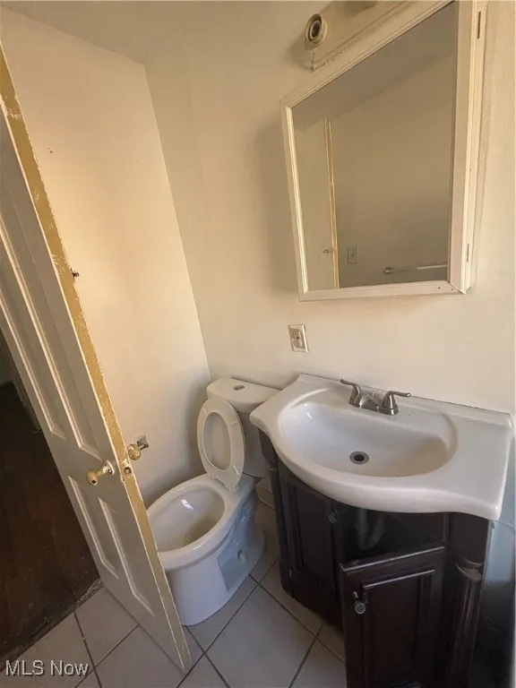 Bathroom featuring tile patterned flooring and vanity