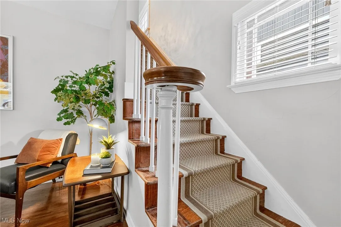 Staircase featuring baseboards and wood finished floors