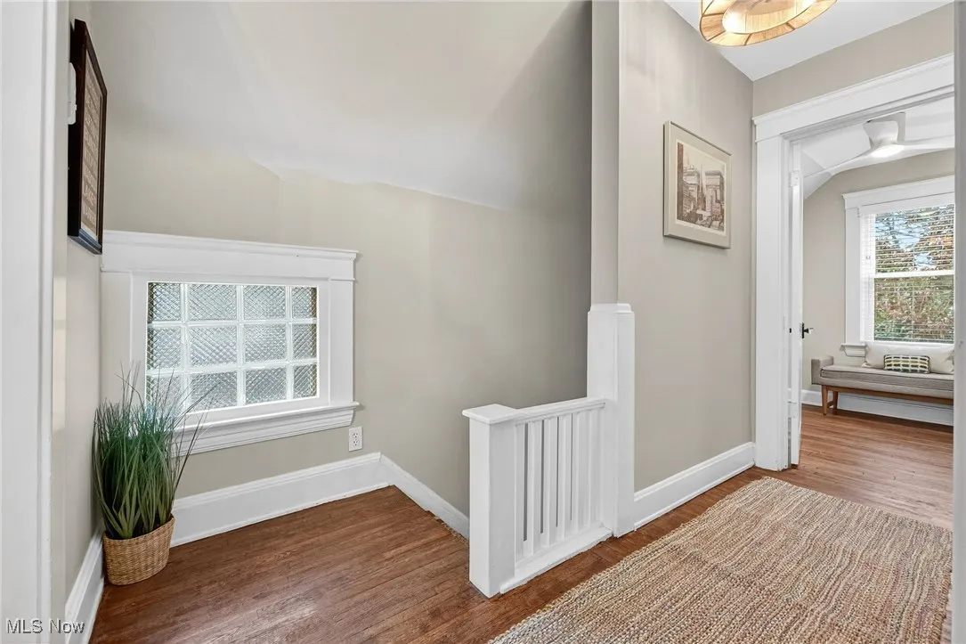 Hall with wood finished floors and baseboards