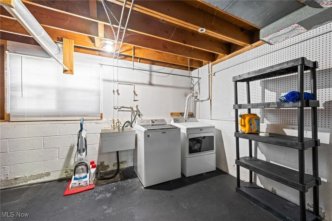 Laundry area with concrete floors and separate washer and dryer