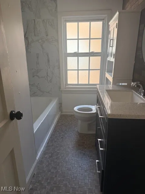 Full bathroom with vanity and shower / washtub combination