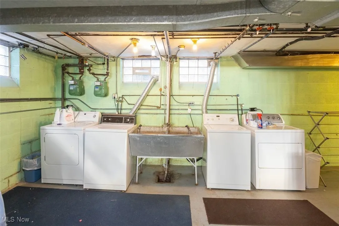 Laundry area with independent washer and dryer and concrete floors