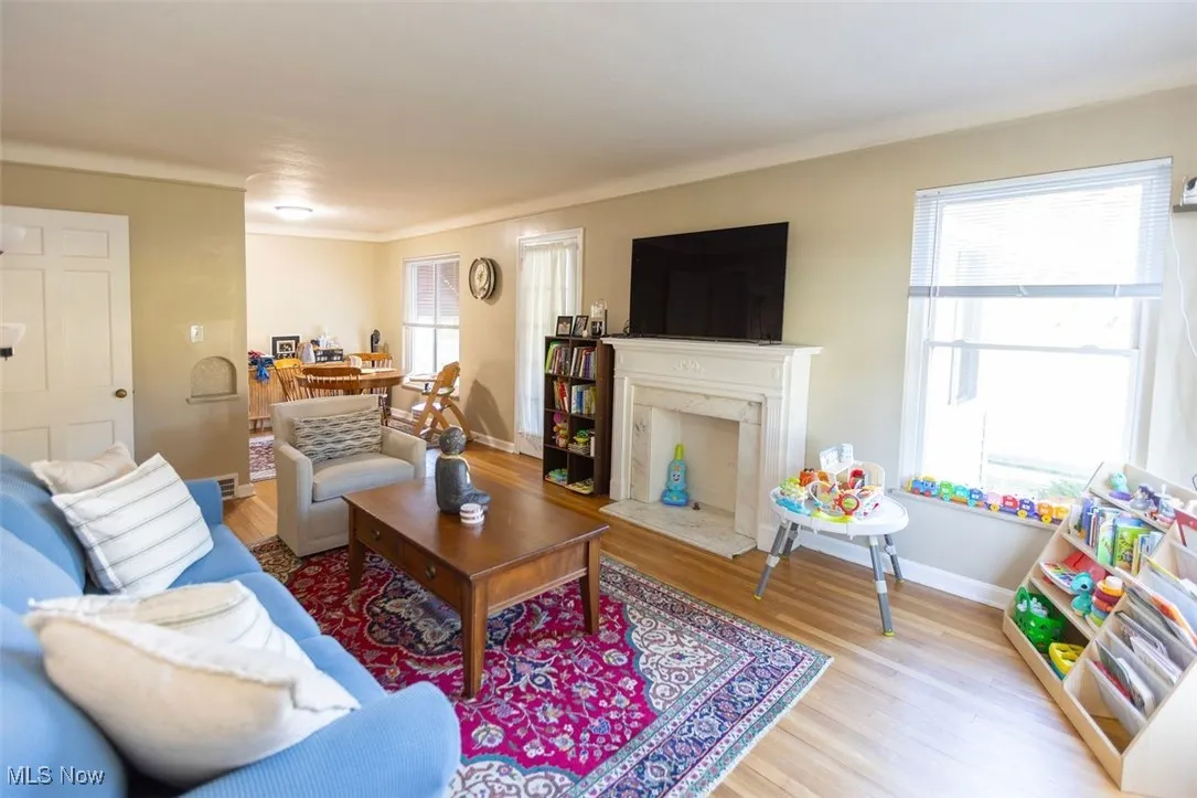 Down unit Living area with light wood-style flooring and a fireplace
