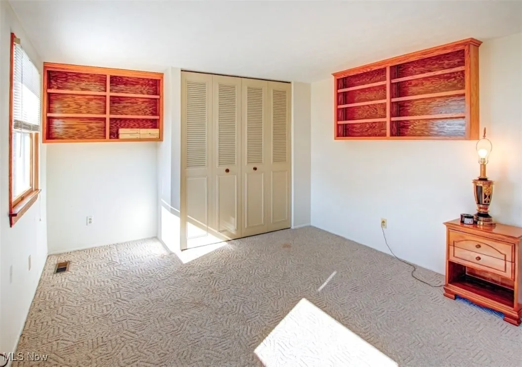 Unfurnished bedroom with carpet floors and a closet