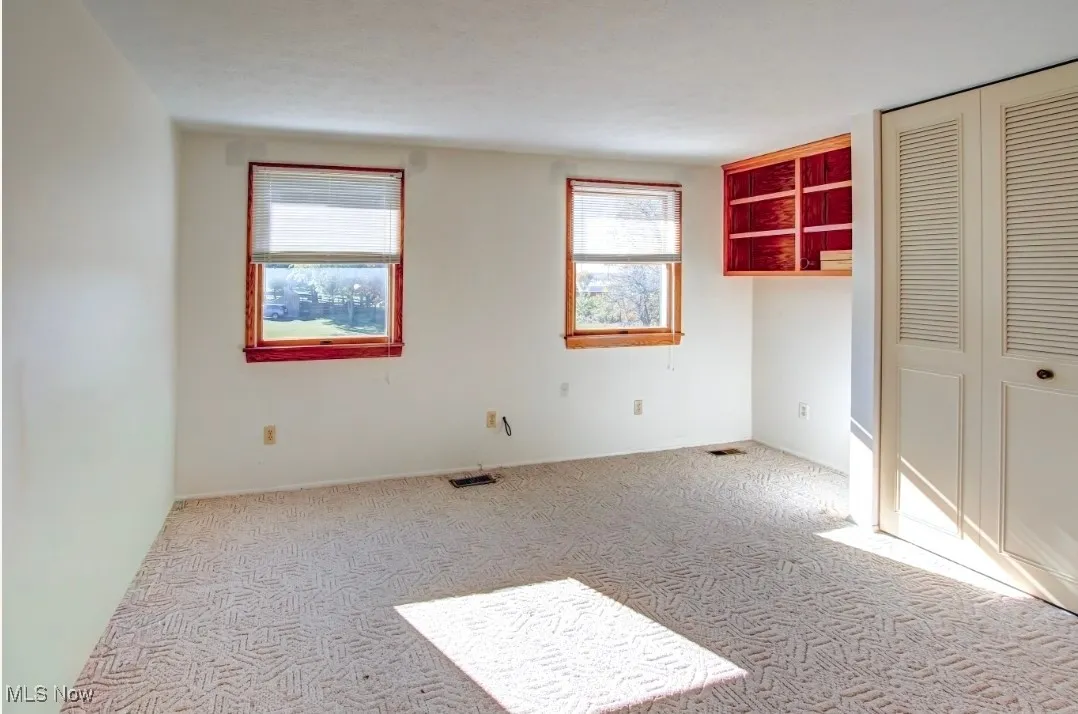 Unfurnished bedroom featuring a closet and carpet floors