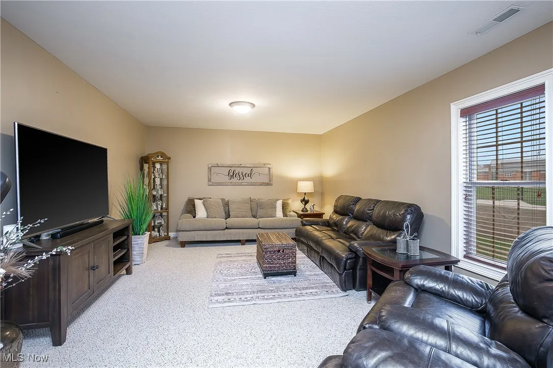 Living area with light colored carpet