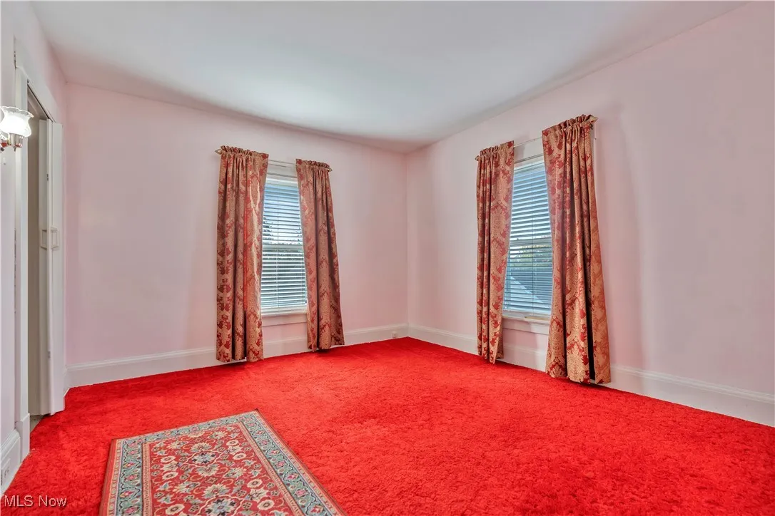 Bedroom 1 with plenty of natural light and carpet