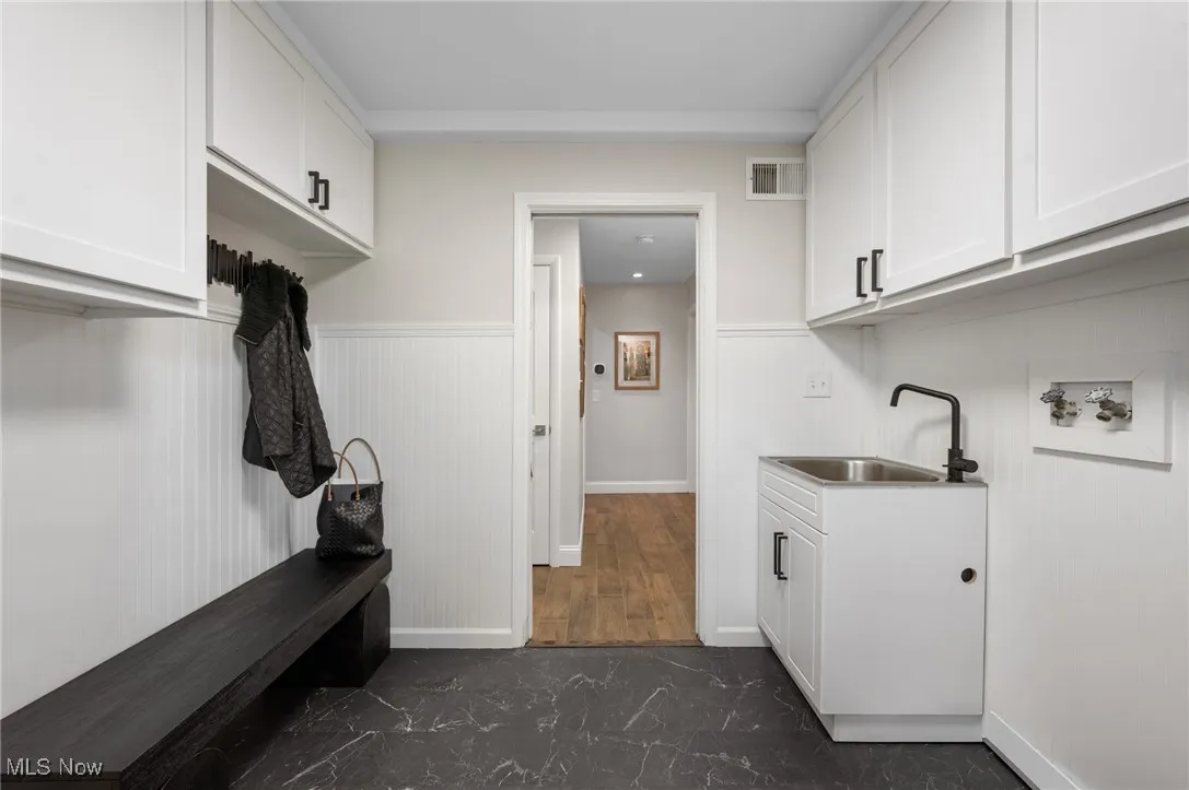 Washer & dryer hookups were maintained during renovation, while Shaker style doors, current flooring and black hardware complete the space.