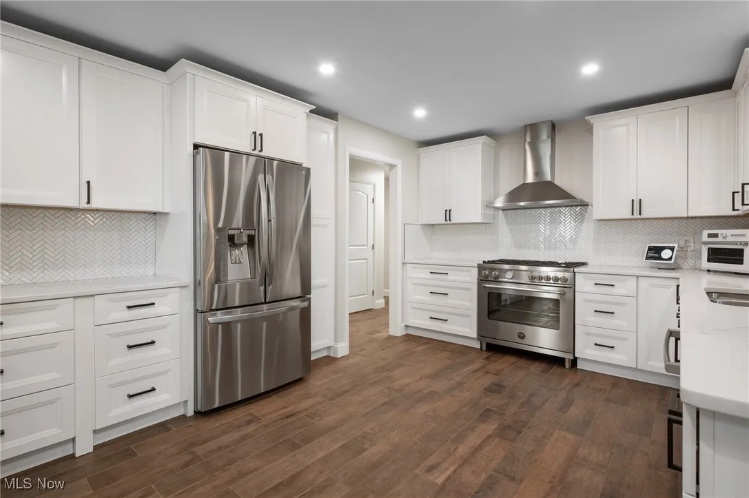 The kitchen was remodeled in 2023, with stainless steel appliances, including a Bertazzoni induction range, quartz countertops, bar seating and easy access from the garage.