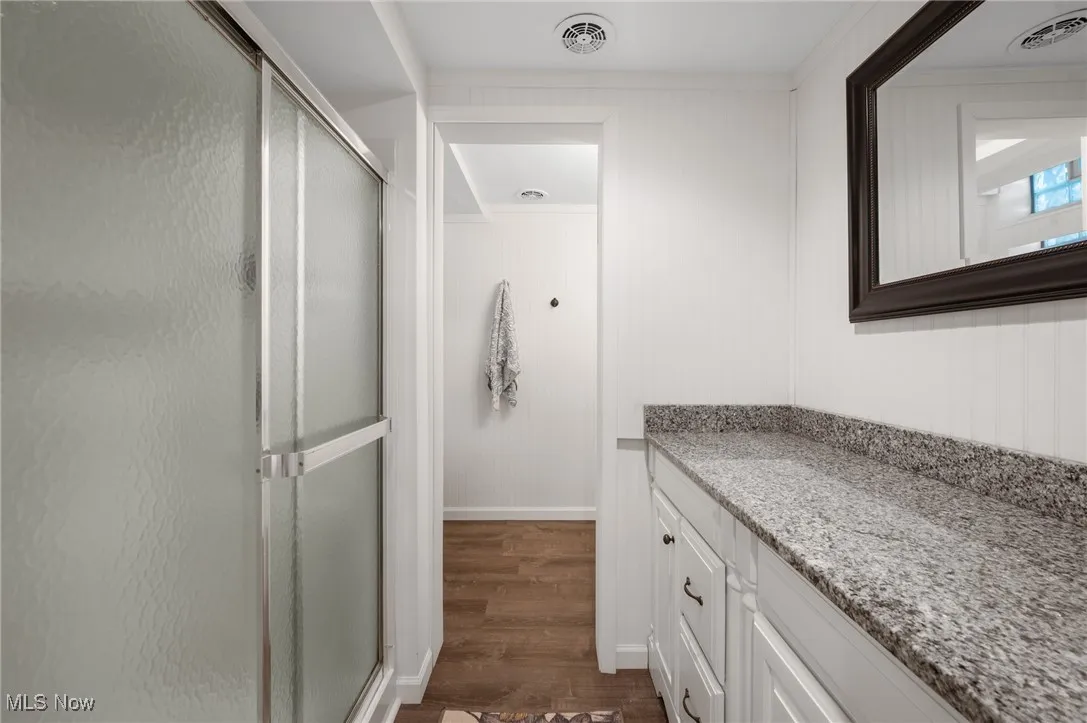 The lower level bathroom is updated with granite countertops in two spaces.