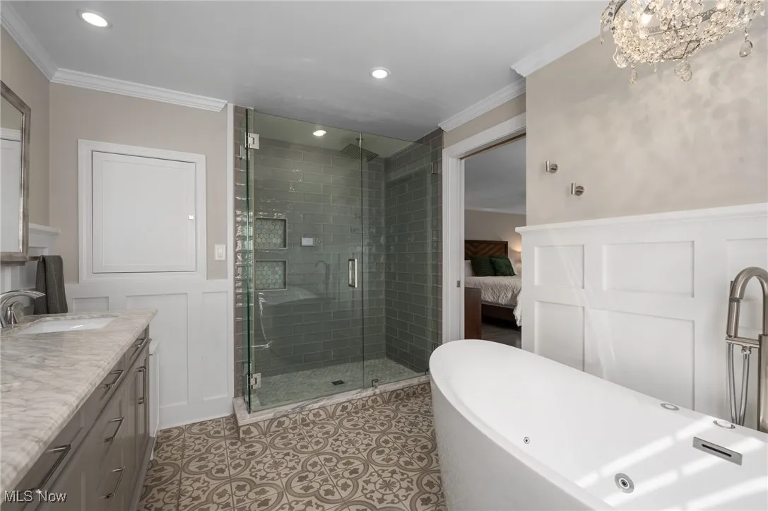 The sizable digitally operated shower is tied to an instant hot water system. The traditional Shaker medicine cabinet allows for tons of storage beyond the vanity cabinets.