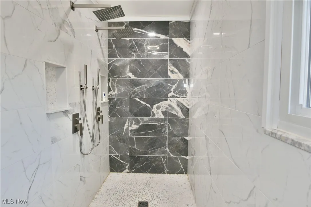 Bathroom with a marble finish shower