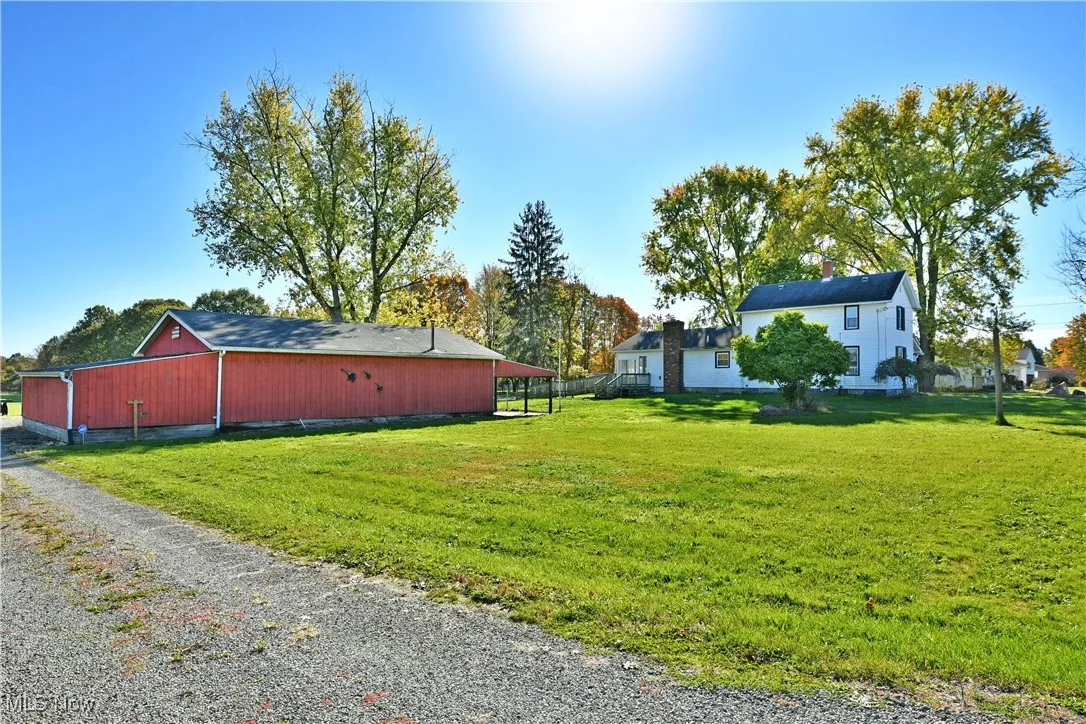 View of property exterior with an outbuilding and an outdoor structure