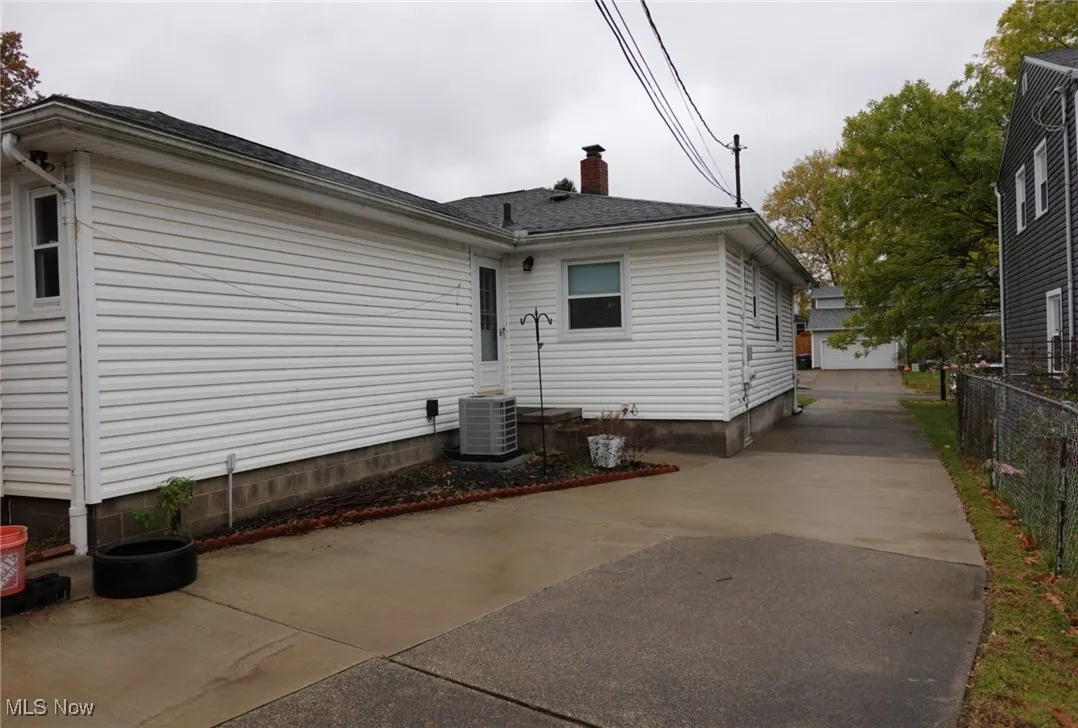 Back of house featuring a chimney