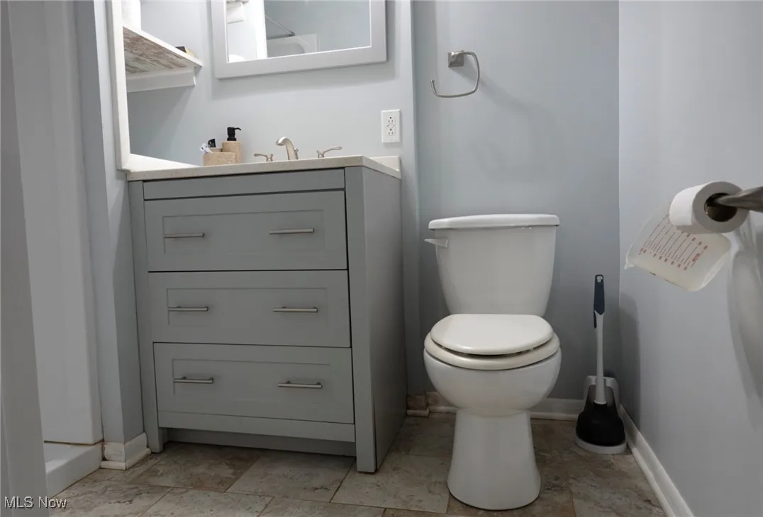 Bathroom featuring vanity and baseboards