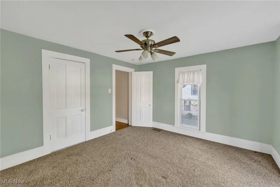 Unfurnished bedroom featuring carpet flooring and a ceiling fan