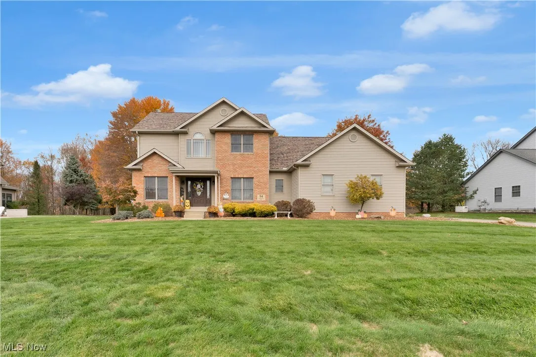 View of front facade with a front yard and brick siding