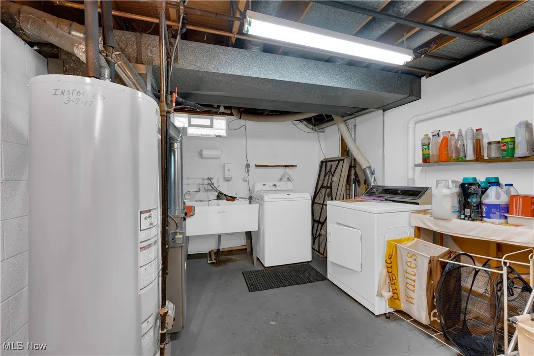 Basement with gas water heater and washer and dryer