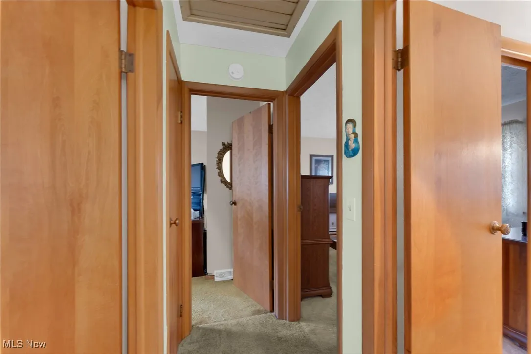 Hall featuring light colored carpet