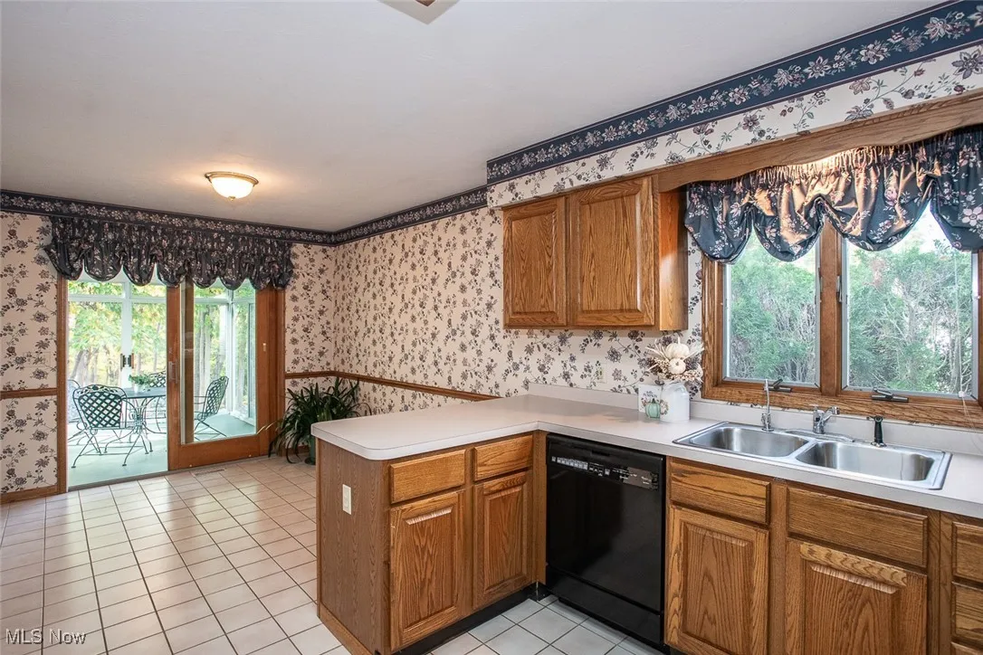 Eat in kitchen with lots of room for a table and chairs. Step through the sliding doors to the enclosed porch with peaceful private wooded views no one behind you, it is a true retreat right at home.