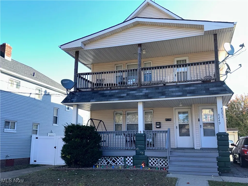 View of front of home with covered porch and a gate