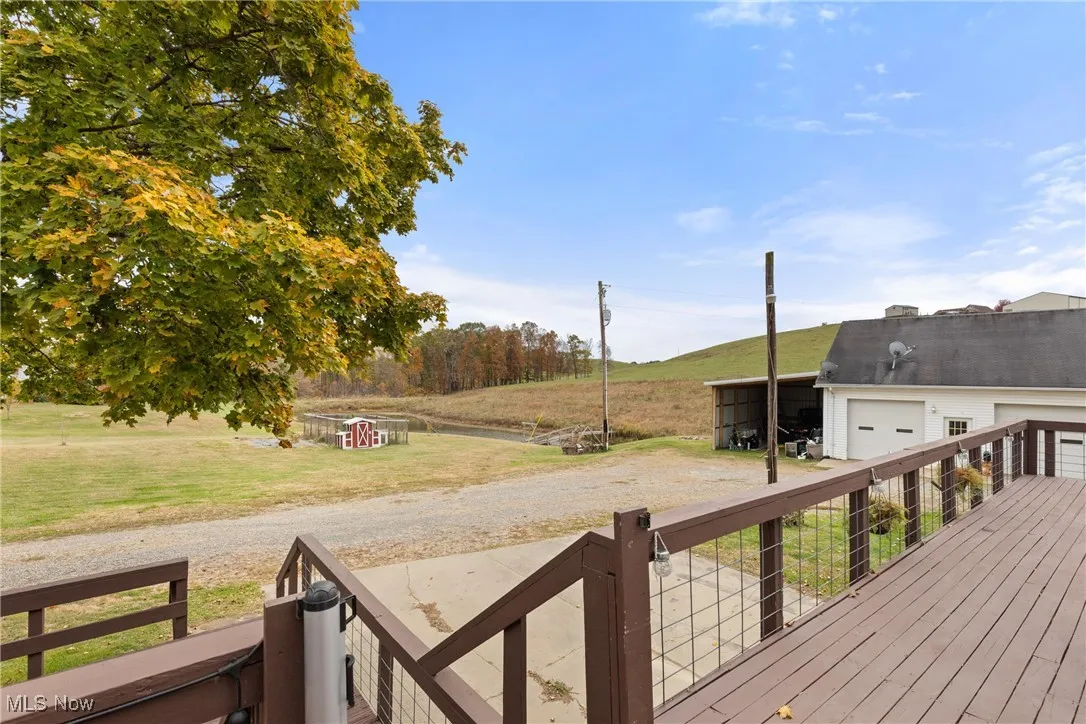 Wooden deck with a yard and a rural view