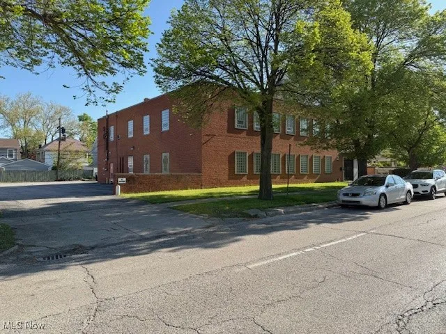 View of side of property featuring brick siding