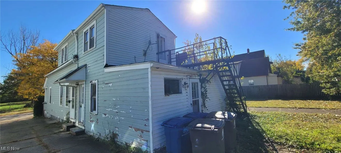View of side of property with stairs