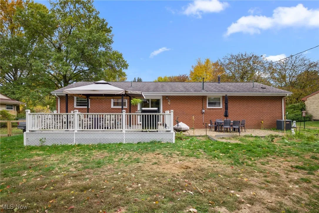 Rear view of property featuring the deck and patio area