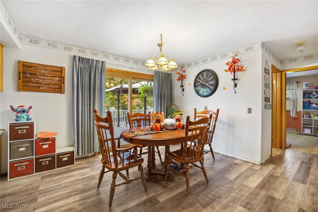 Dining room featuring LVT floors and back door