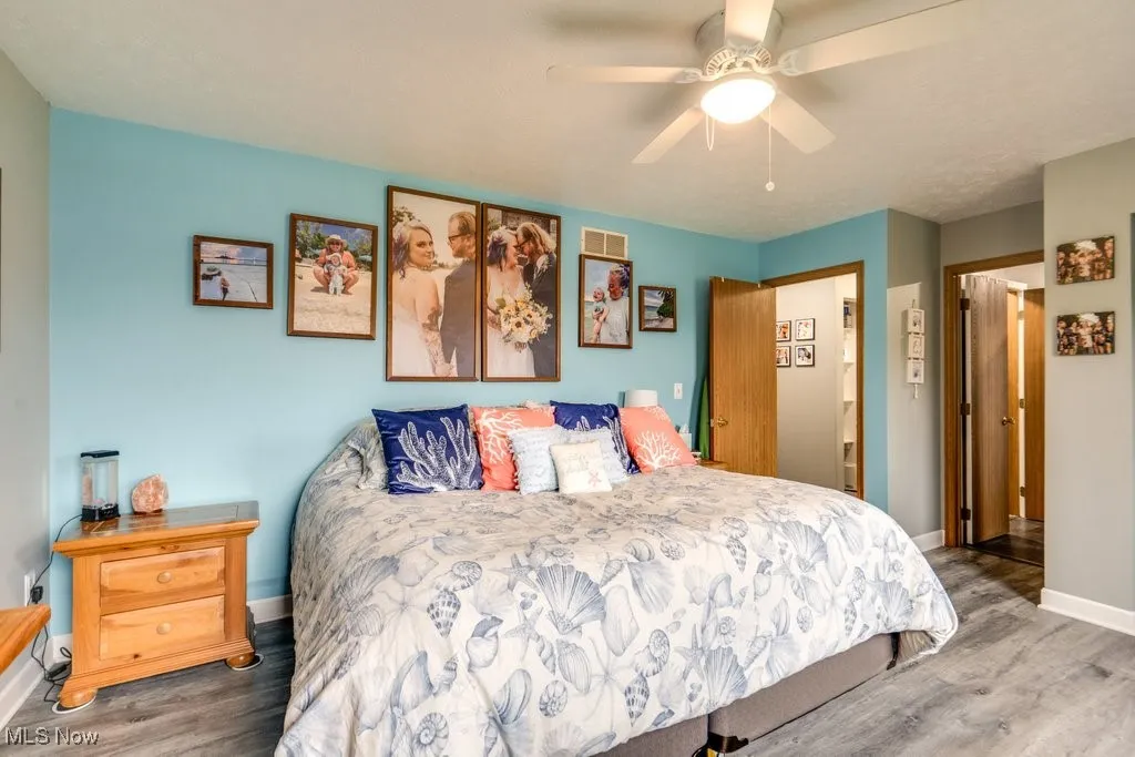 Bedroom featuring wood finished floors and a ceiling fan