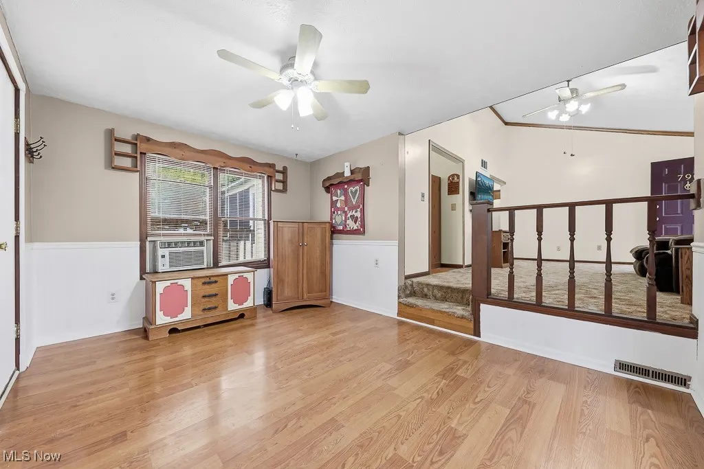 Dining room featuring light wood finished floors, a ceiling fan, and cooling unit
