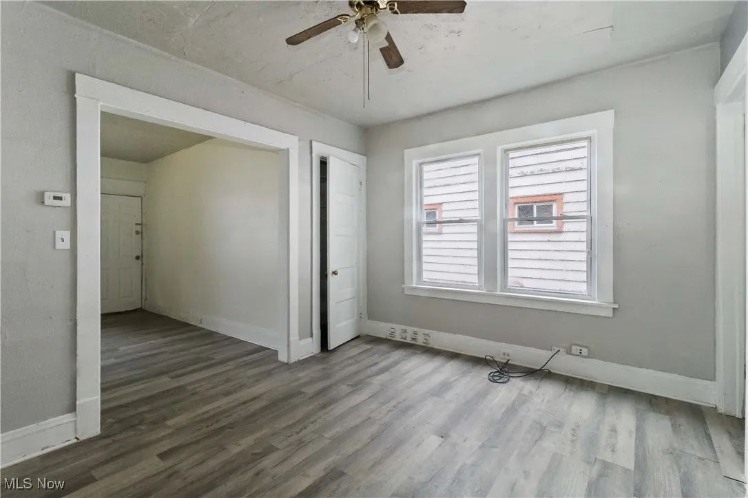 Unfurnished bedroom featuring wood finished floors and a ceiling fan