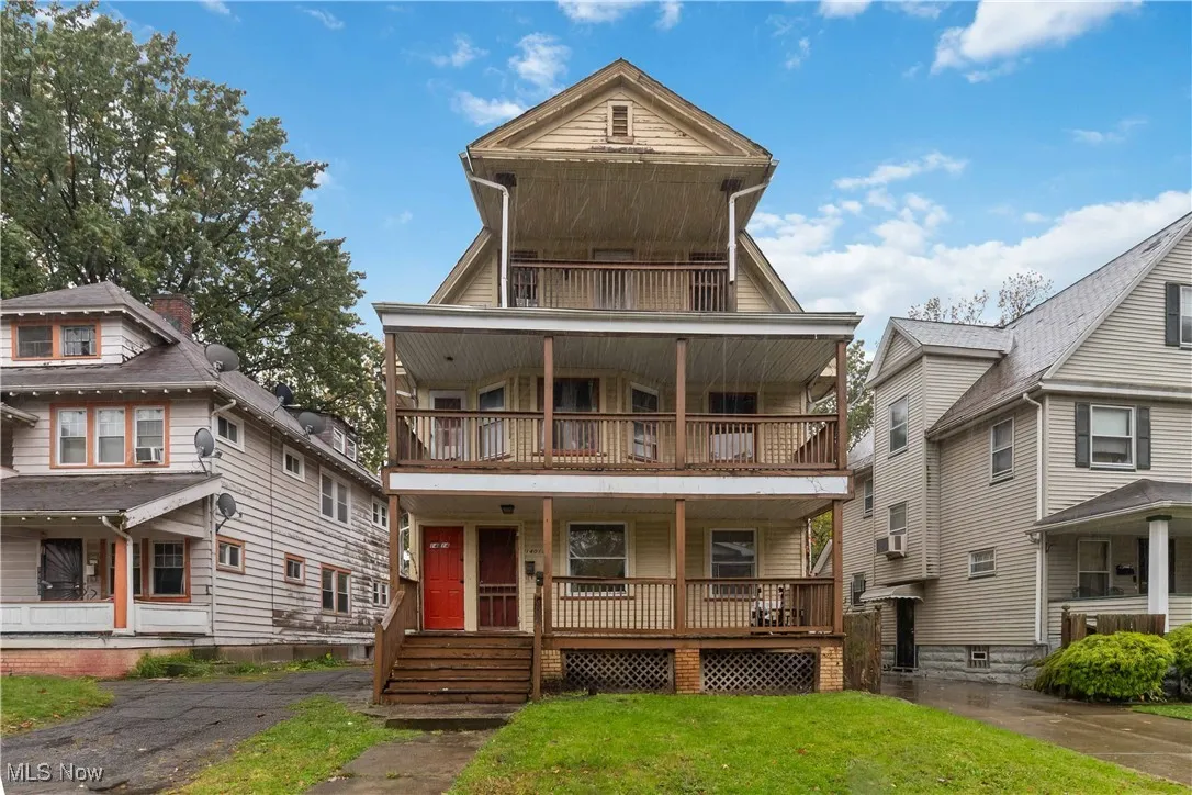 View of front of property featuring covered porch and a front lawn