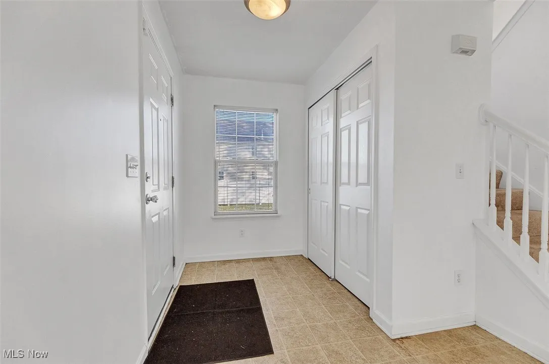 Entryway & view of spacious coat closet