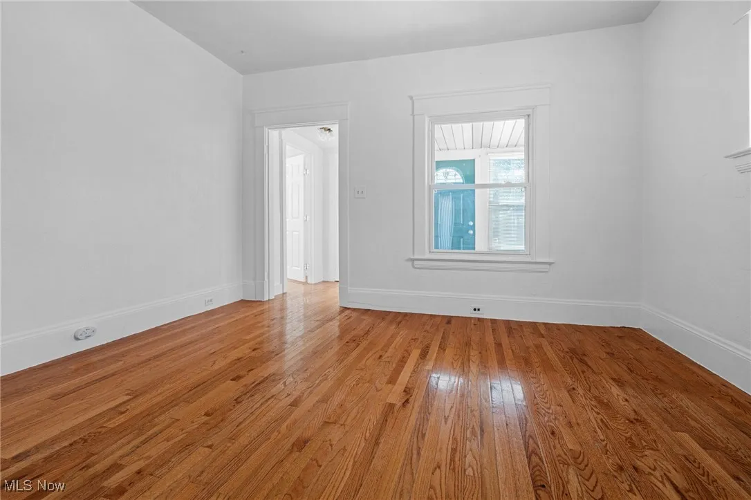 Empty room featuring hardwood / wood-style floors and baseboards
