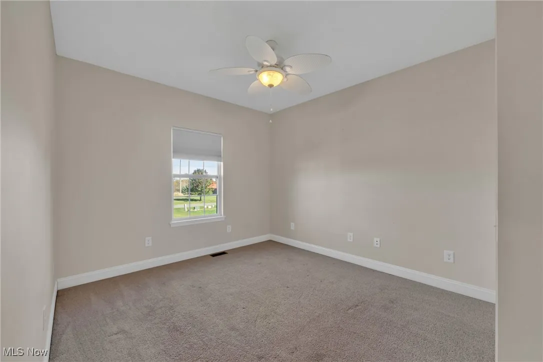 Unfurnished room with light carpet and ceiling fan